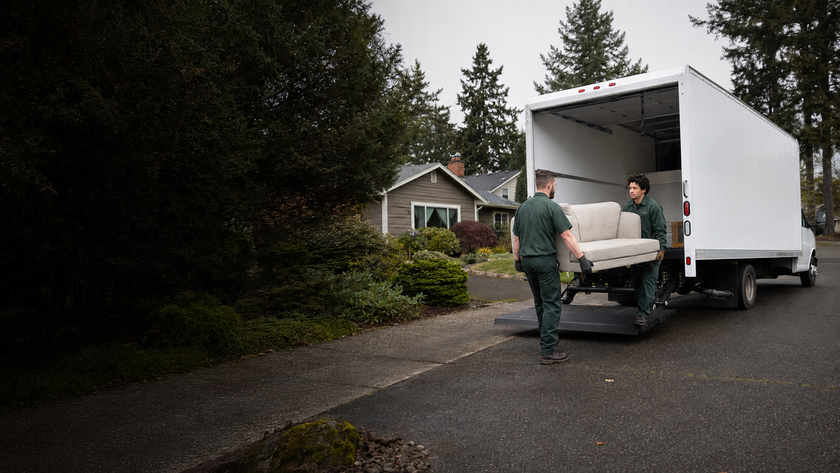 Professional junk removal crew working beside a clean truck at a Pacific Northwest home